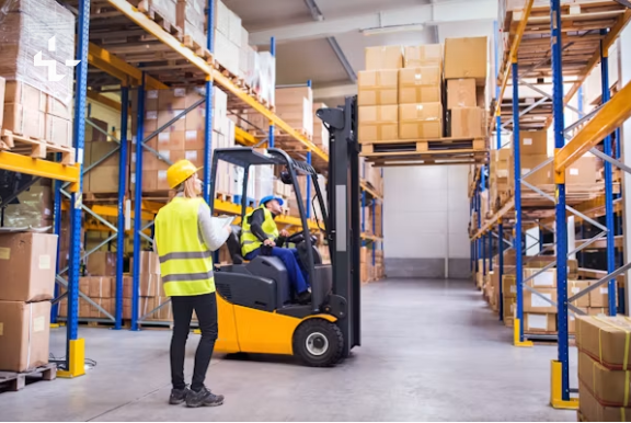 Just-In-Time (JIT): The Cornerstone of Manufacturing Excellenc Workers handling containers on a production line using kanban principles in JIT inventory management