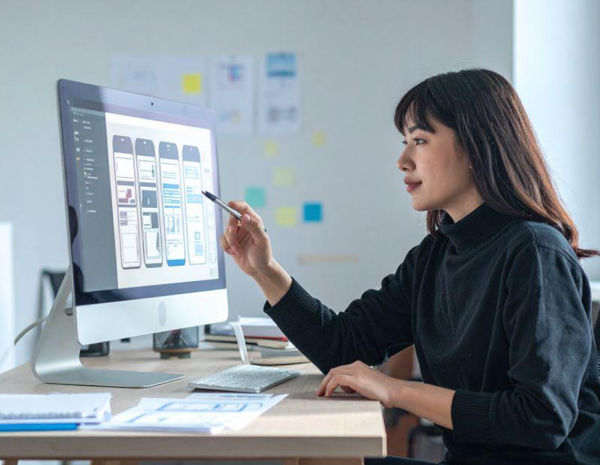 UI UX designer reviewing digital interface layouts and design components