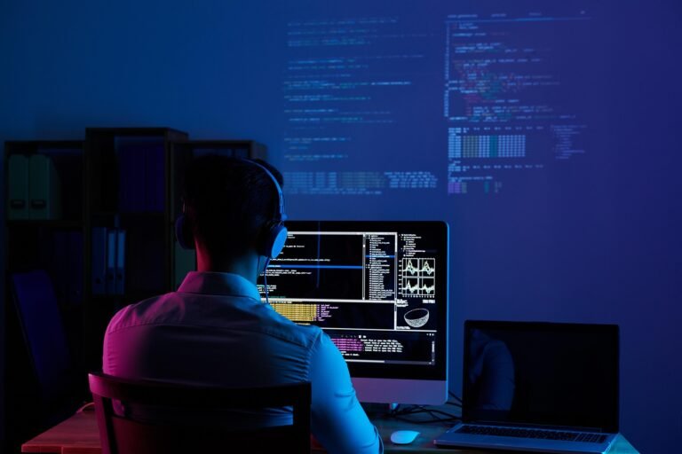 Web Developer Resume Keywords: Skills and Examples Web developer working on a laptop with coding tools