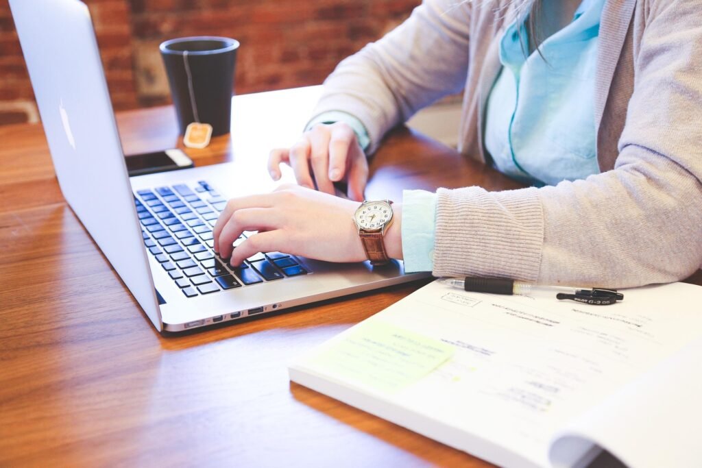 Professional writing retail resume keywords on a laptop