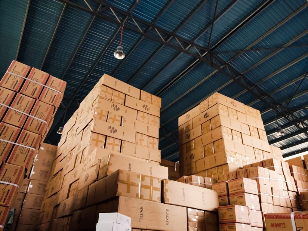 Warehouse interior with tall storage racks and stacked boxes